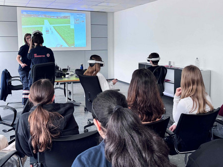 Junge Mädchen probieren ein VR-System aus, weshalb sie VR-Brillen aufhaben.